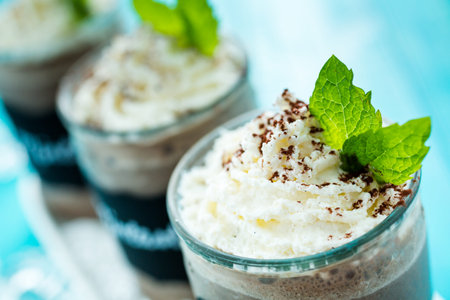 Gourmet cold mintastic chocolate drink garnished with cocoa powder and mint.
