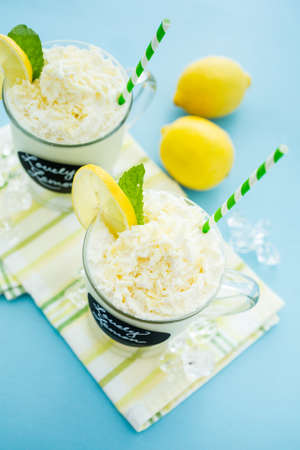 Gourmet cold lovely lemon chocolate drink garnished with white chocolate, lemon and mint.の写真素材