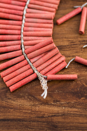 Roll of firecrackers on wood table.