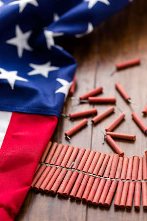 Roll of firecrackers with folded American flag.の写真素材