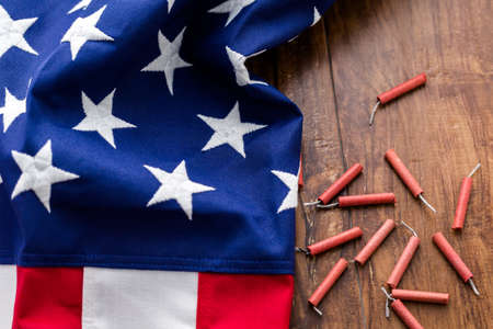 Roll of firecrackers with folded American flag.の写真素材