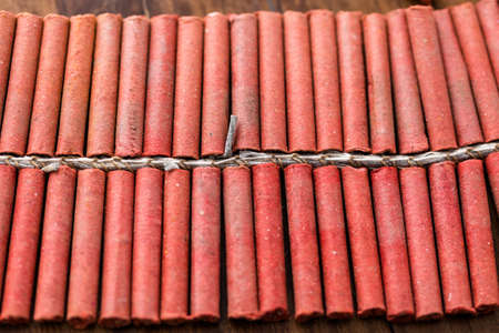 Roll of firecrackers on wood table.の写真素材