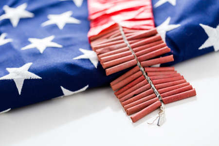 Roll of firecrackers with American flag on a white background.の写真素材