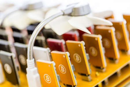 Row of USB bitcoin miners plugged into large USB board.の写真素材