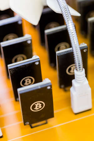 Row of USB bitcoin miners plugged into large USB board.の写真素材