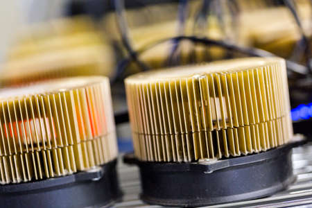 Row of litecoin miners set up on the wired shelfs.の写真素材