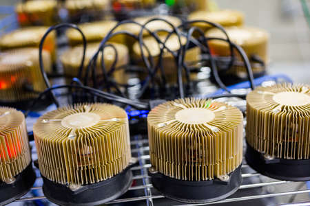 Row of litecoin miners set up on the wired shelfs.の写真素材