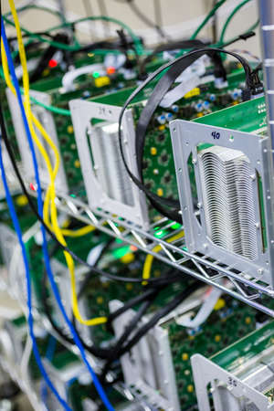 Denver, Colorado, USA-August 13, 2014. Row of bitcoin miners set up on the wired shelfs.のeditorial素材
