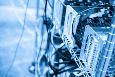 Denver, Colorado, USA-August 13, 2014. Row of bitcoin miners set up on the wired shelfs.のeditorial素材