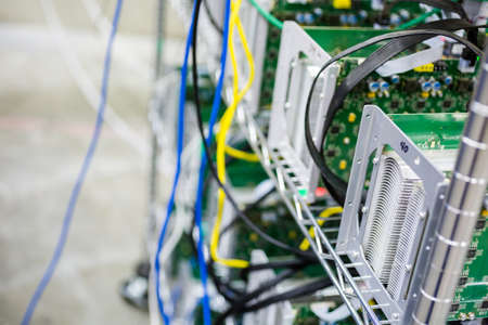 Denver, Colorado, USA-August 13, 2014. Row of bitcoin miners set up on the wired shelfs.のeditorial素材