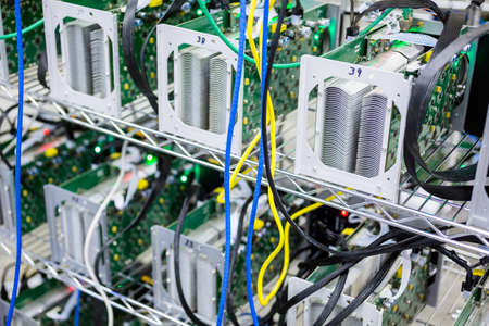 Denver, Colorado, USA-August 13, 2014. Row of bitcoin miners set up on the wired shelfs.のeditorial素材