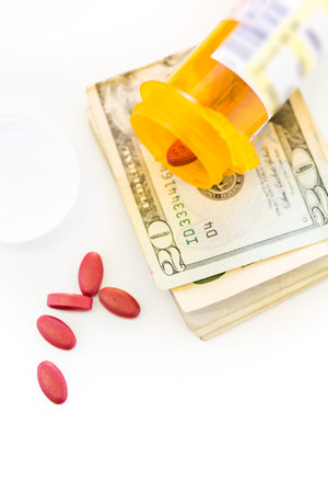 Prescription pills in yellow bottles on a white background.