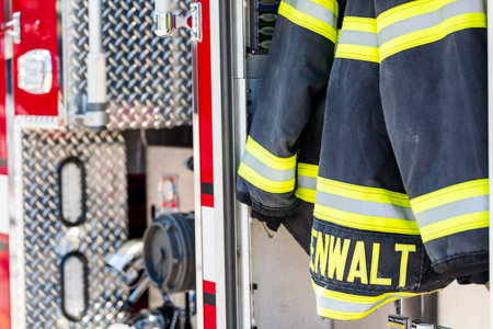 Firefighter clothing hanging on fire truck.の写真素材