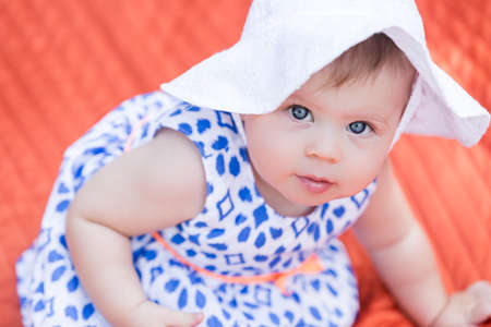 Cute babies playing on the blanket on backyard.の写真素材