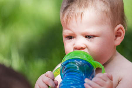 Cute babies playing on the blanket on backyard.の写真素材