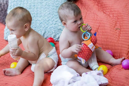 Cute babies playing on the blanket on backyard.の写真素材