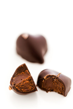 Gourmet 85% Coure d'Or chocolate truffles in heart shape on a white background.の写真素材