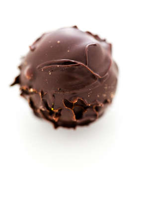 Gourmet dark chocolate truffle on a white background.の写真素材