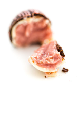 Gourmet strawberry chocolate truffle on a white background.