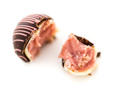 Gourmet strawberry chocolate truffle on a white background.