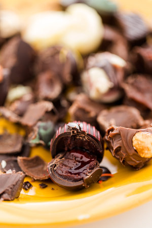 Crashed gourmet chocolate truffles on yellow plate.の写真素材