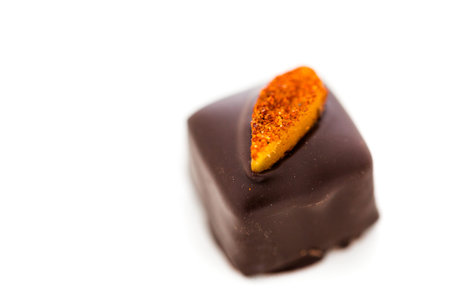 Gourmet mango chili vegan truffle on a white background.