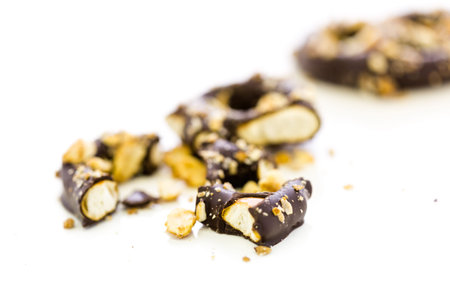 Gourmet chocolate covered pretzel with candy peanuts on a white background.の写真素材