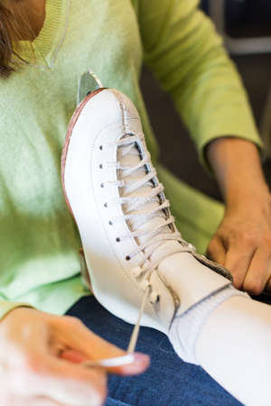 Cute young girl practicing figure skating on indoor ice skating rink.の写真素材