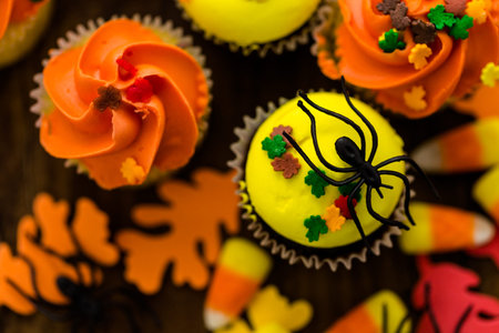 Assorted cupcakes with yellow and orange icing decorated for Autumn.の写真素材