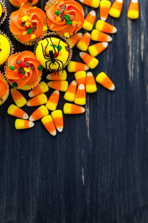 Assorted cupcakes with yellow and orange icing decorated for Autumn.の写真素材