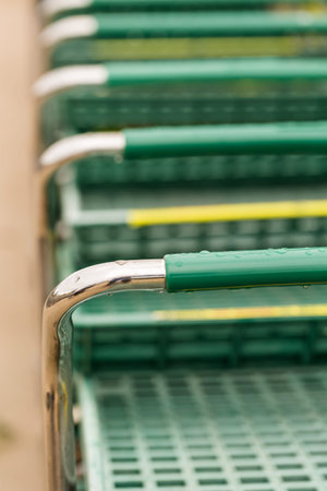 Large green shopping cart in a row.