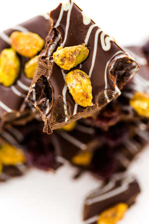 Gourmet Pistachio cherry chocolate bar on a white background.の写真素材