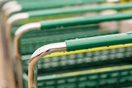Large green shopping cart in a row.の写真素材