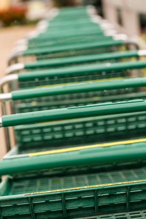 Large green shopping cart in a row.の写真素材