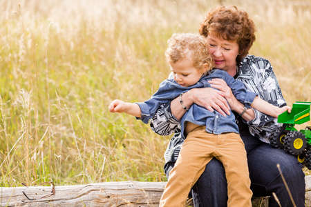 Lovely family enjoying weekend in open space park in early Autumn.の写真素材