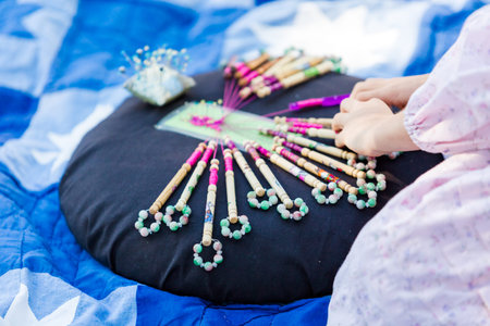 Display of vintage bobbin lace craft on historical ranch.