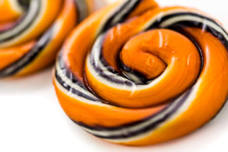 Handmade twist lollipop with orange and black stripes.の写真素材