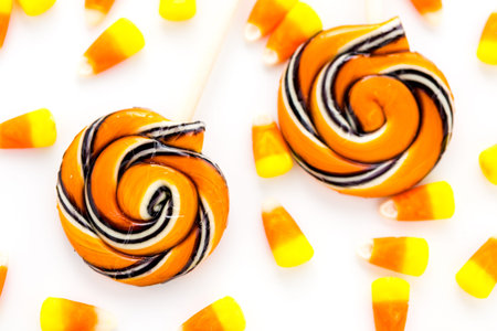Handmade twist lollipop with orange and black stripes.の写真素材