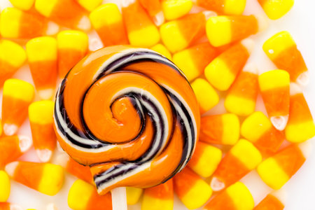 Handmade twist lollipop with orange and black stripes.の写真素材