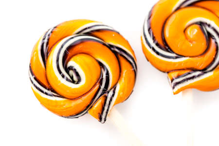 Handmade twist lollipop with orange and black stripes.の写真素材