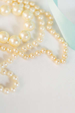 White vintage pearls on the table.の写真素材
