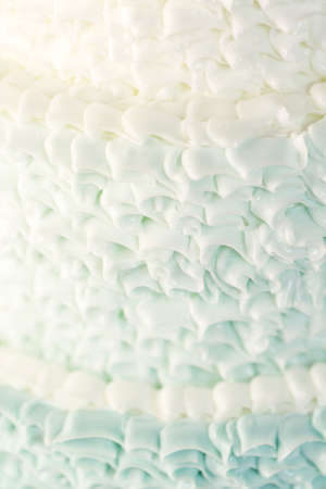 Gourmet tiered wedding cake as centerpiece at the wedding reception.の写真素材