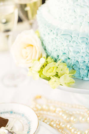 Gourmet tiered wedding cake as centerpiece at the wedding reception.の写真素材