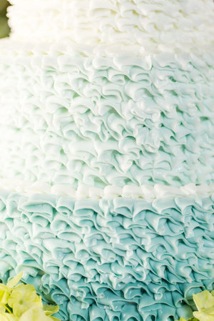 Gourmet tiered wedding cake as centerpiece at the wedding reception.の写真素材