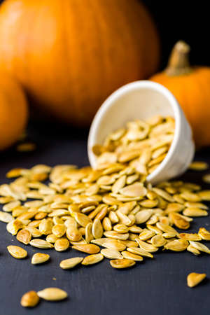 Home  cooked pumpkin seeds on black background.の写真素材