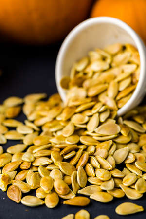 Home  cooked pumpkin seeds on black background.の写真素材