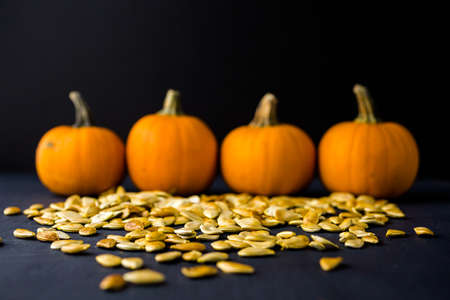 Home  cooked pumpkin seeds on black background.の写真素材