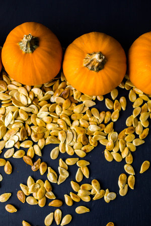 Home  cooked pumpkin seeds on black background.の写真素材
