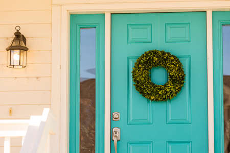 Green wreath decorating front door.のeditorial素材