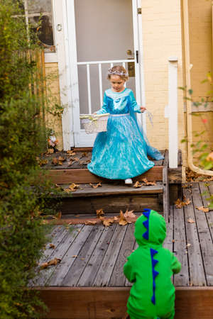 Trick or treating in costumes on Halloween night.の写真素材